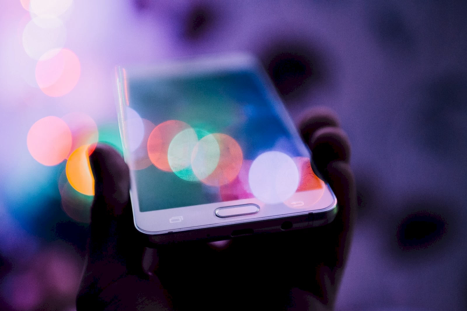 <p>person holding smartphone. Photo by Rodion Kutsaev, Unsplash.</p>